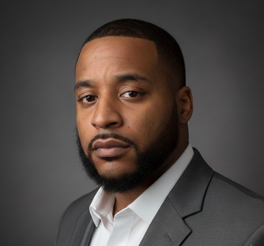 Professional headshot of a business owner wearing a suit jacket
