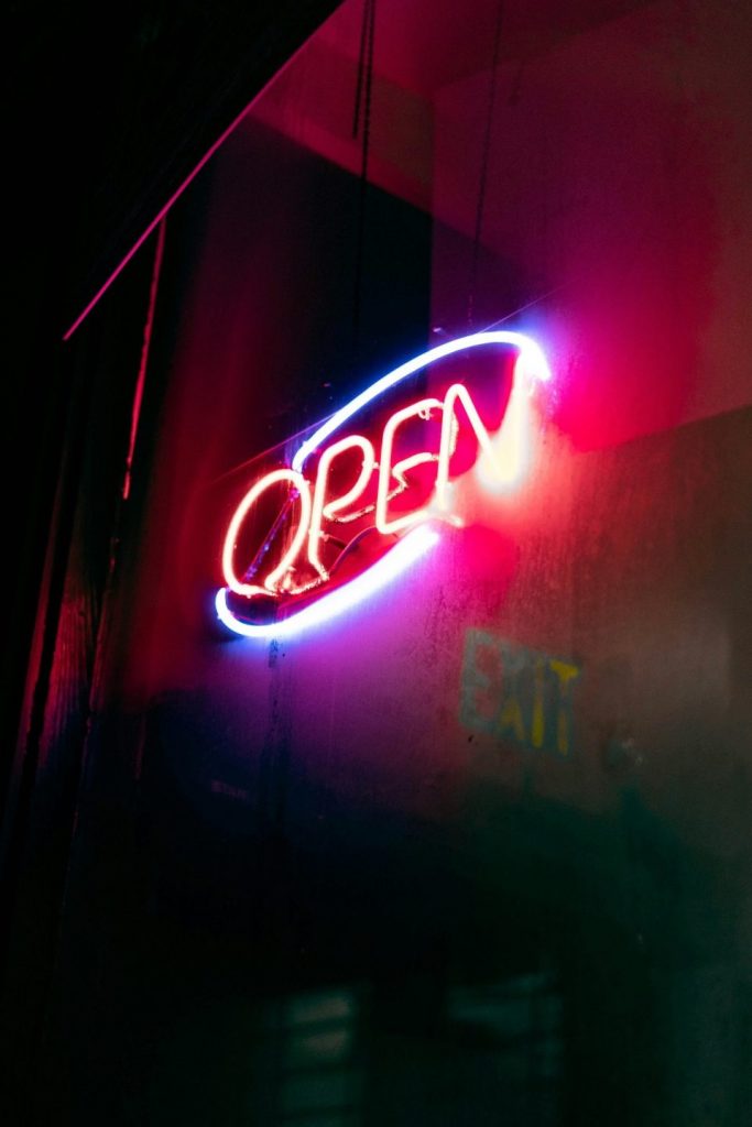 Neon “Open” sign glowing at night, symbolizing availability and late-night service